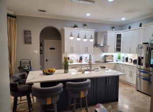 State-of-the-art kitchen with appliances, island, and coffee station.